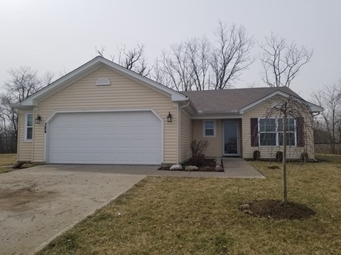 a beige house with a white garage door